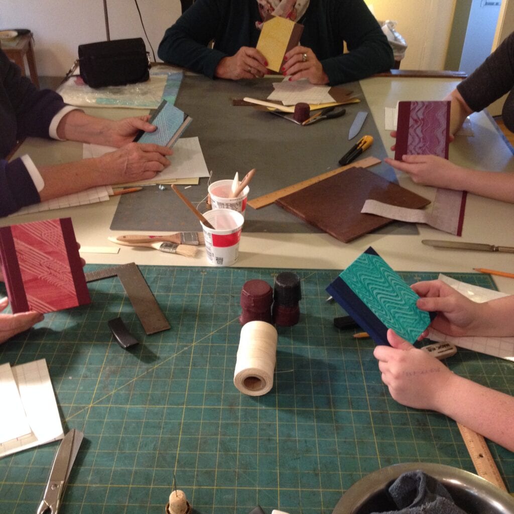 A group of people sitting around a table with papers.